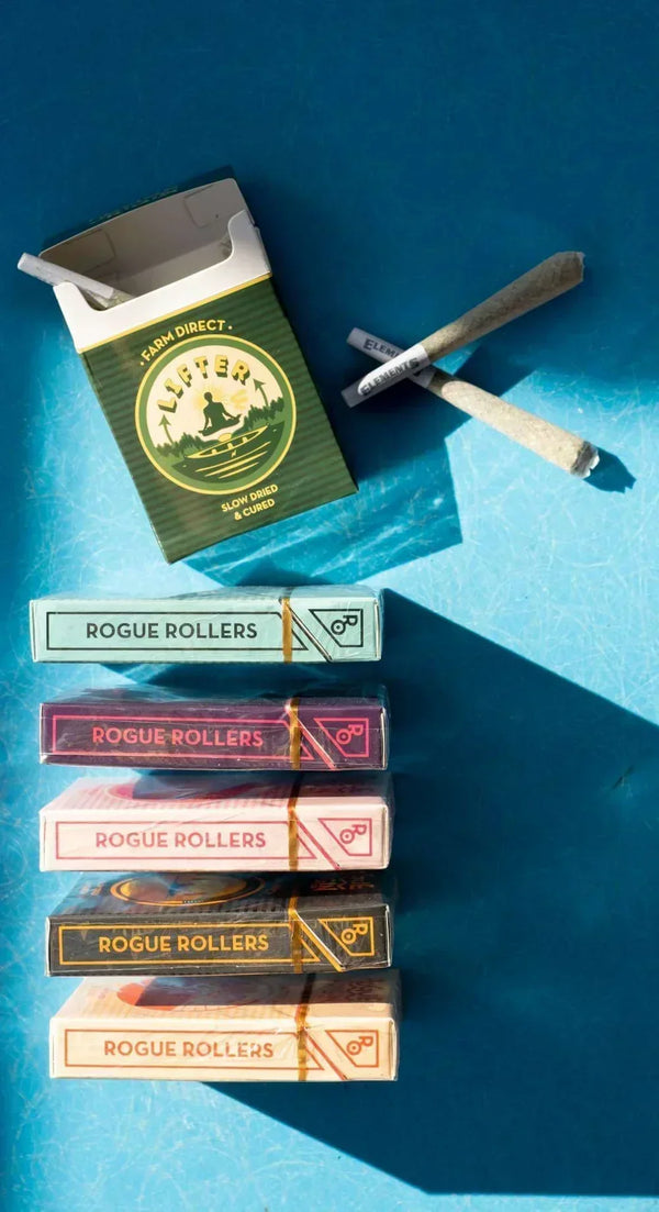 Rogue Rollers boxes and hemp prerolls showing how prerolls are made with packed cones and finished preroll packs