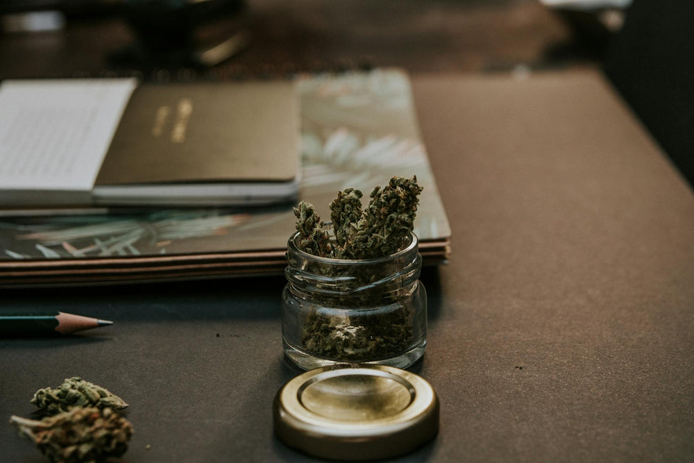 A book about if THCA is legal in all 50 states next to CBD hemp flower