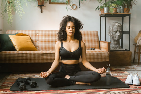 A woman meditating and practicing mindfulness with CBD