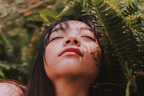 woman with her head back feeling